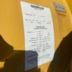 a yellow metal container with a white label