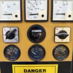 a yellow panel with black dials and gauges