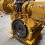a large yellow diesel engine in a warehouse