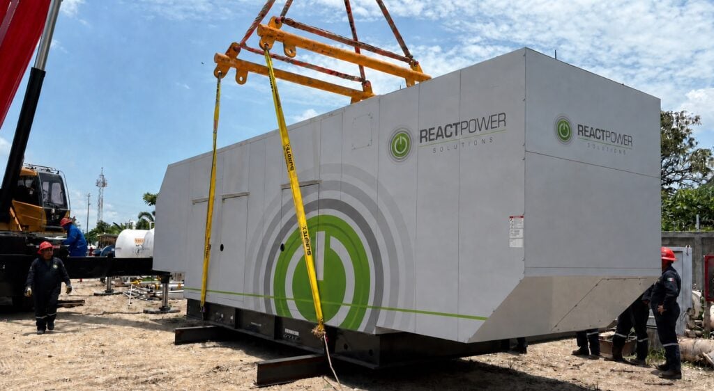 Large portable power module/container being lifted by crane at a construction site, with workers guiding it and ReactPower Solutions branding visible on the unit.